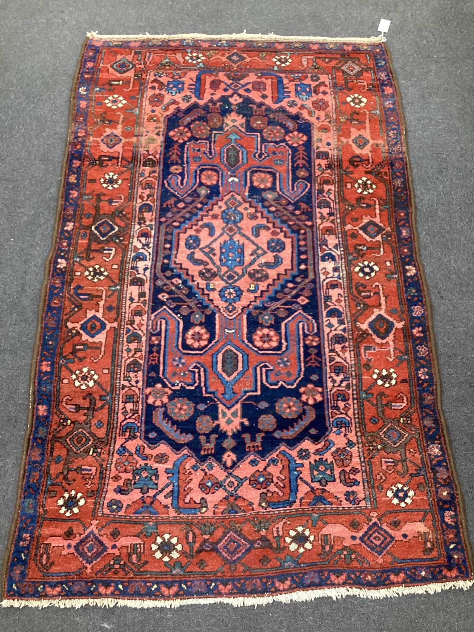 A Kurdish blue ground rug, 186 x 114cm